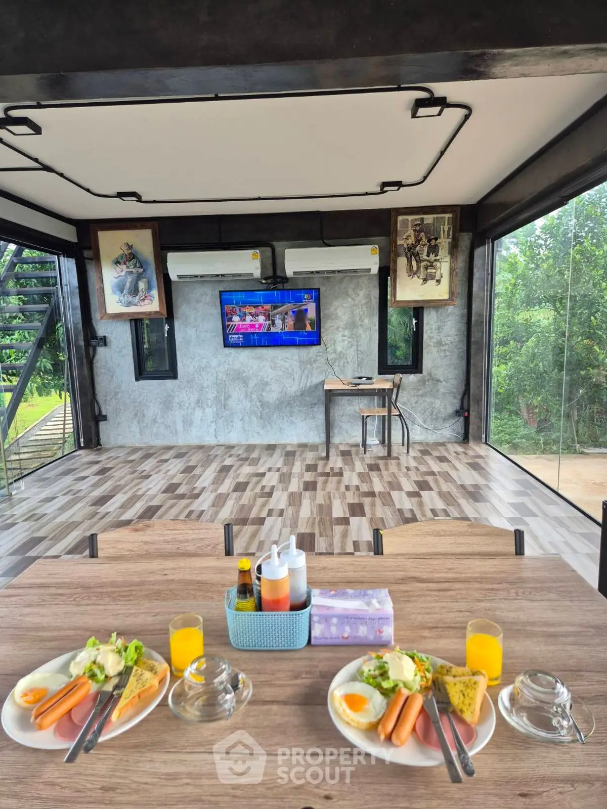 Modern open-plan living area with breakfast setup and scenic views