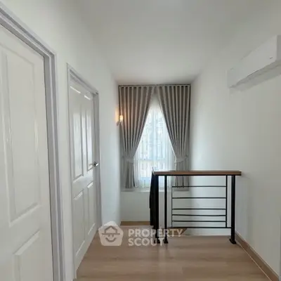 Bright hallway with modern railing and elegant curtains in a stylish home interior.