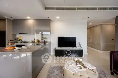 Modern living room with sleek kitchen and stylish decor in luxury apartment.