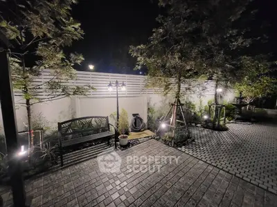 Charming night garden with elegant lighting and cozy seating area