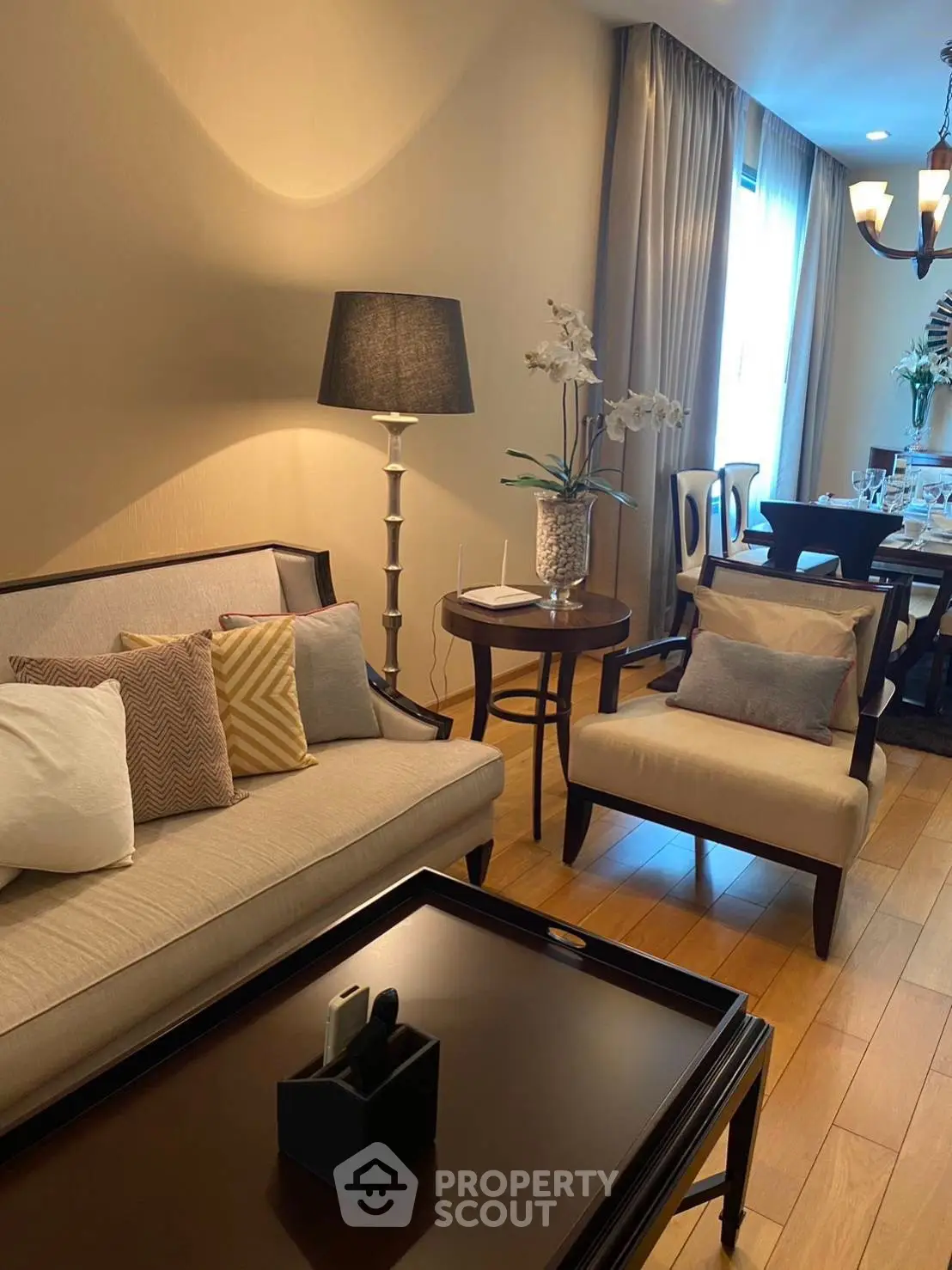 Elegant living room with stylish furniture and dining area, perfect for modern living.