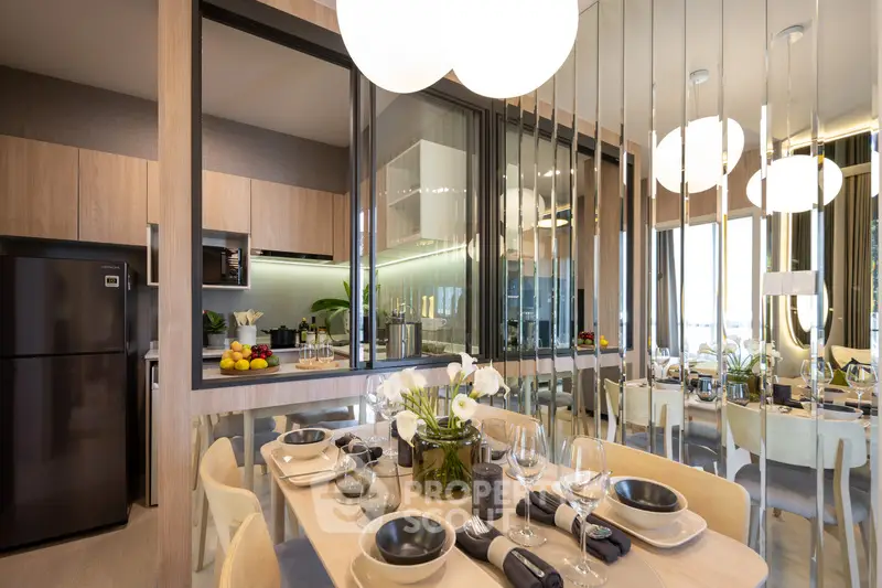 Modern dining area with elegant table setting and mirrored wall in stylish apartment