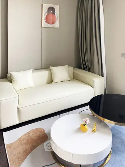 Modern living room with elegant white sofa and stylish round coffee table
