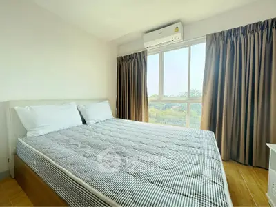 Bright and airy bedroom with large window and air conditioning unit