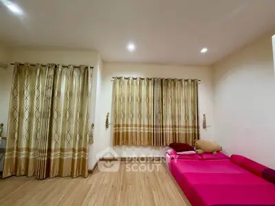 Spacious bedroom with elegant curtains and cozy pink bedding, perfect for relaxation.