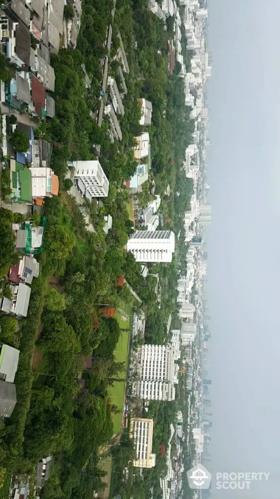 Stunning aerial view of urban landscape with lush greenery and modern buildings