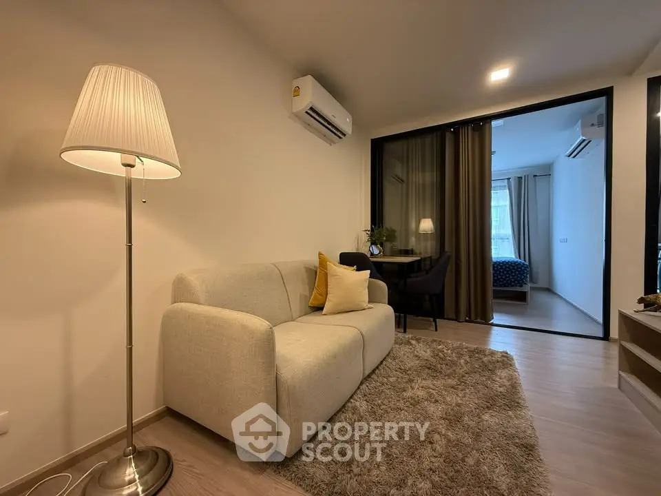 Modern living room with cozy sofa and stylish decor in a contemporary apartment.