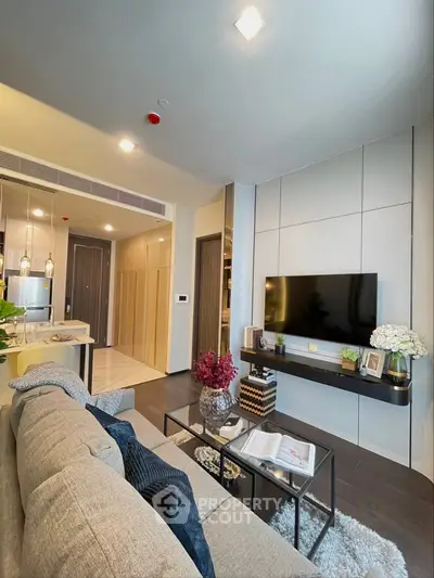 Modern living room with stylish decor and open kitchen layout in a contemporary apartment.