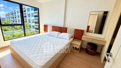 Modern bedroom with large window and scenic view in a stylish apartment