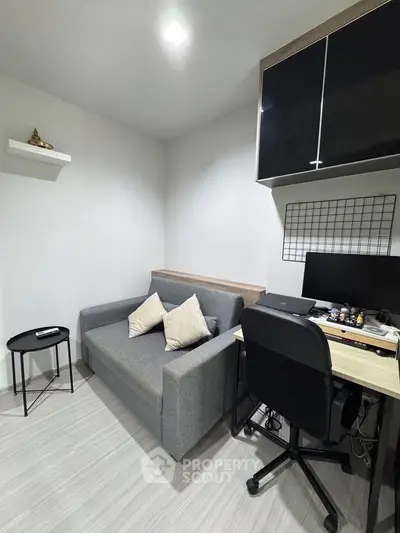 Modern study room with sleek desk, comfortable sofa, and stylish decor in a contemporary apartment.