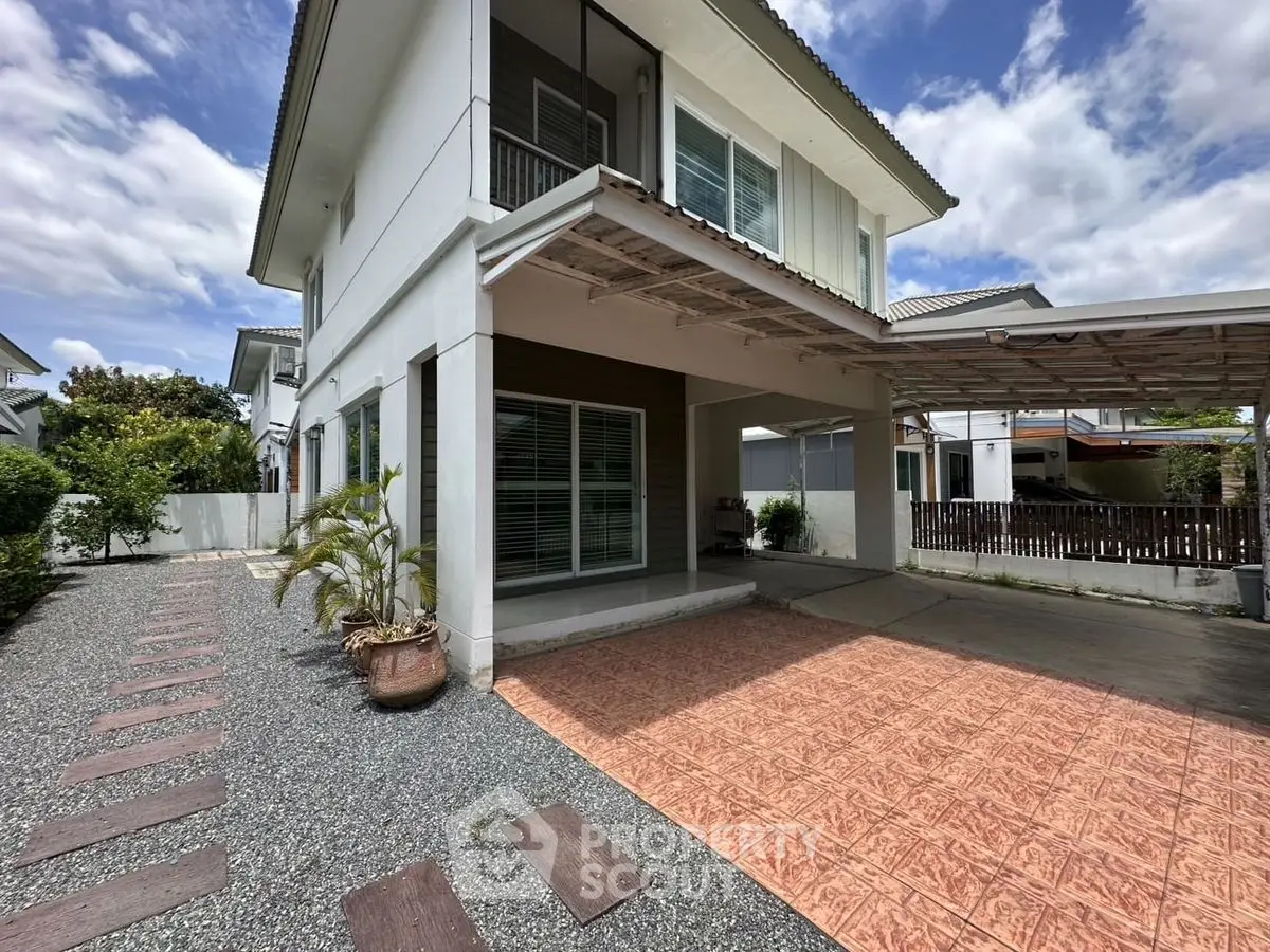 Modern two-story house with spacious driveway and landscaped garden