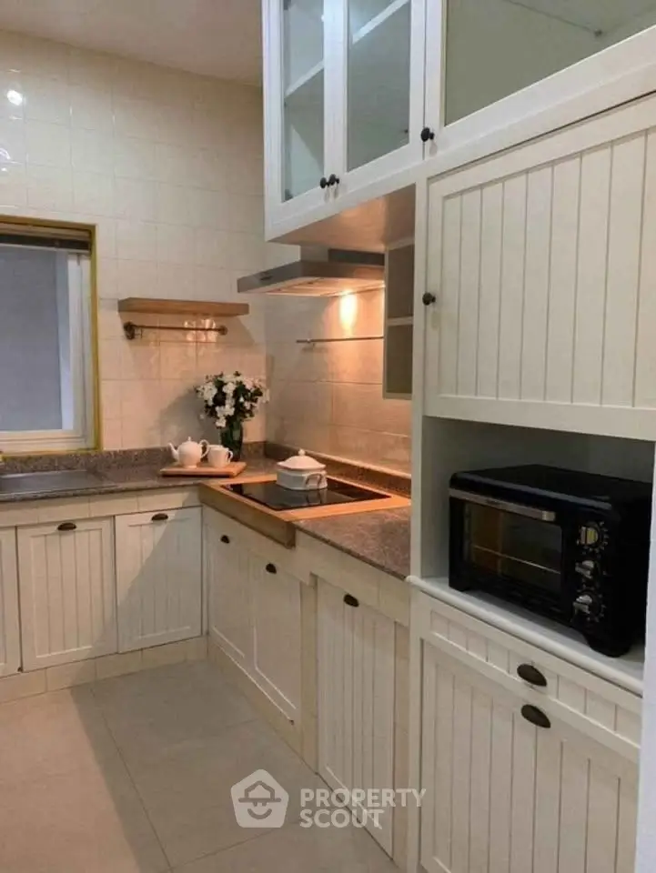 Charming kitchen with classic cabinetry and modern appliances, perfect for culinary enthusiasts.
