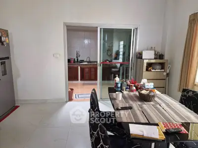 Spacious kitchen with dining area and modern appliances, perfect for family gatherings.