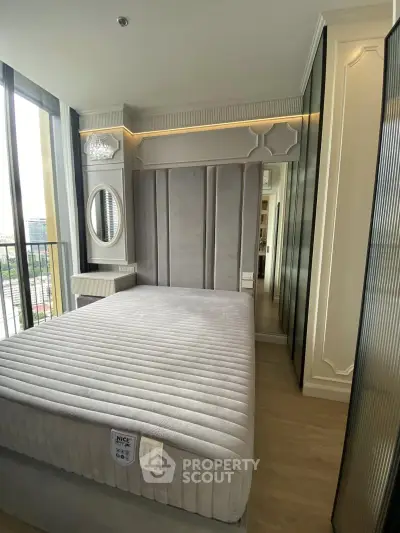 Luxurious bedroom with plush bed and mirrored wardrobe in modern apartment