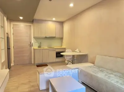 Modern compact living room with integrated kitchen and cozy seating area