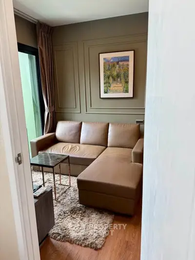 Cozy living room with brown leather sofa and elegant wall art, perfect for relaxation.