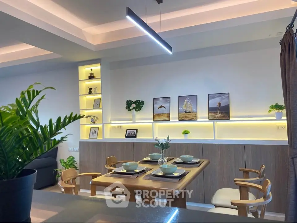 Modern dining area with stylish lighting and elegant decor in a contemporary home.