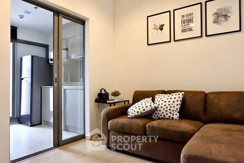 Modern living room with cozy sofa and open kitchen layout in stylish apartment.