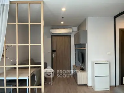 Modern apartment interior with open living and dining area, featuring stylish furniture and neutral tones.