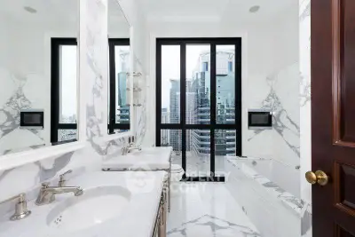 Luxurious marble bathroom with city view and elegant fixtures