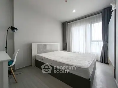 Modern minimalist bedroom with large window and natural light
