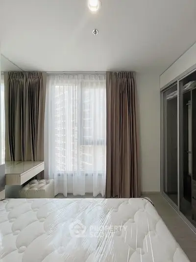 Modern bedroom with large window and elegant curtains in a high-rise apartment.