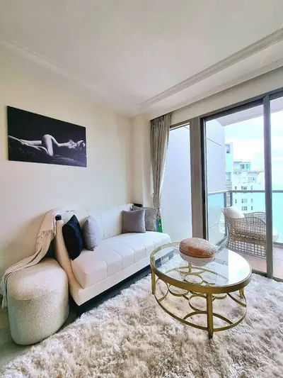 Stylish living room with plush rug and elegant furniture overlooking city view