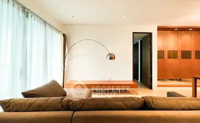 Spacious modern living room with elegant lighting and cozy sofa, perfect for relaxation and entertainment.