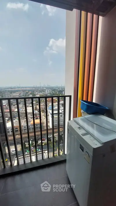High-rise balcony with city view and washing machine, perfect for urban living.