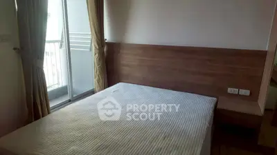 Cozy bedroom with balcony access and wooden headboard