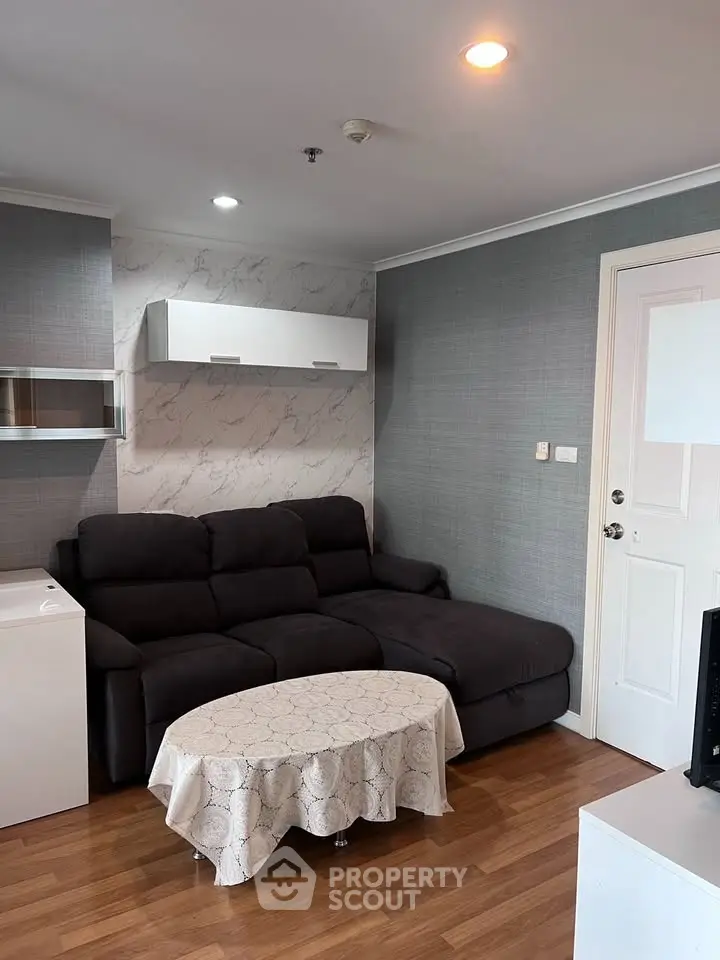 Cozy living room with modern decor and comfortable seating in a stylish apartment.