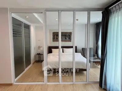 Modern bedroom with glass sliding doors and elegant decor
