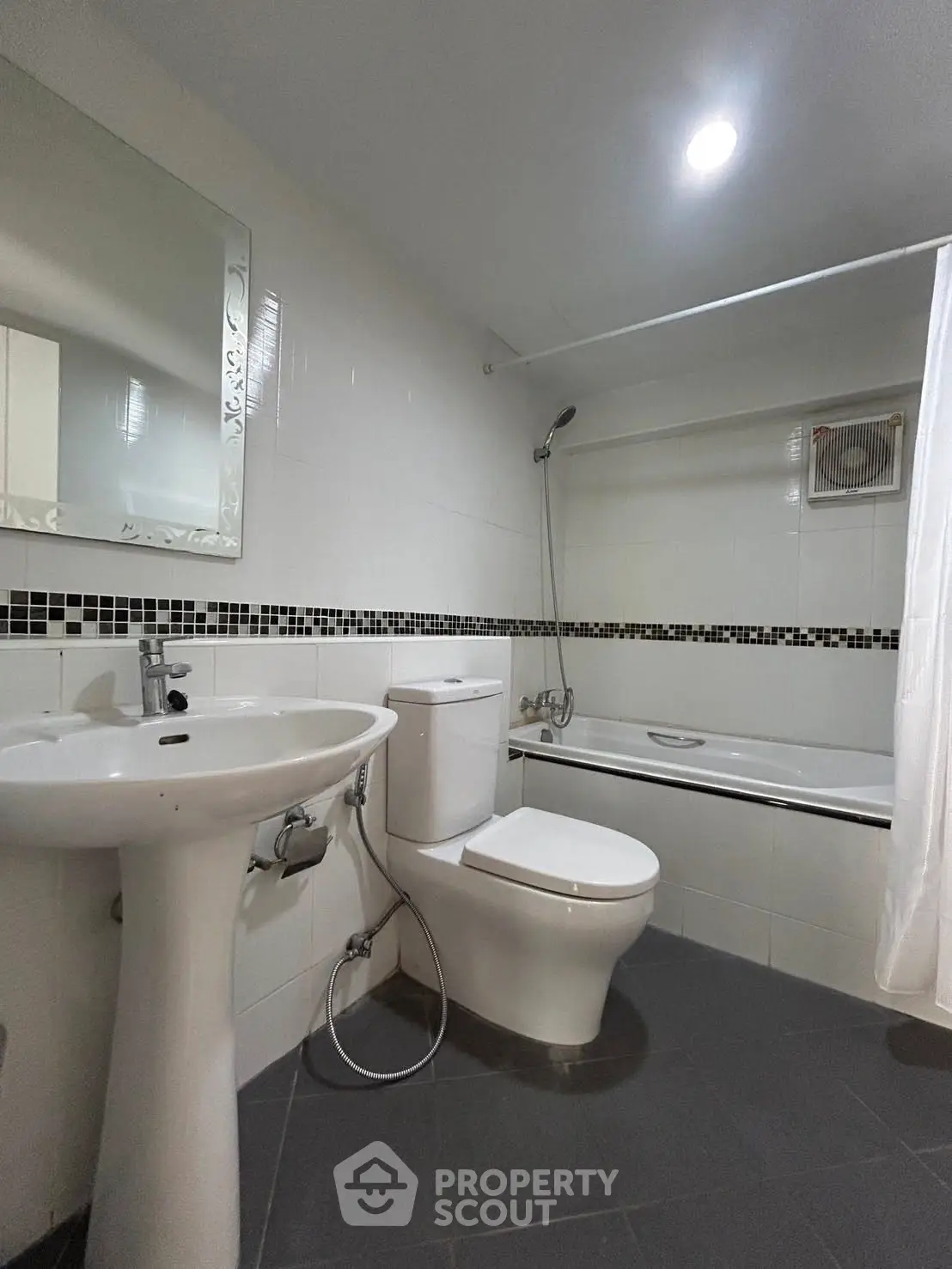 Modern bathroom with sleek fixtures and bathtub in a contemporary apartment.