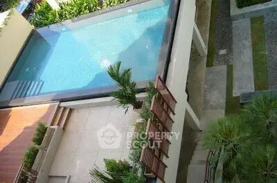 Luxurious rooftop pool with modern design and lush greenery