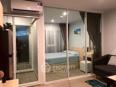Modern bedroom with glass sliding doors and cozy decor in a stylish apartment.