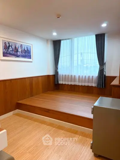 Charming interior space with wooden flooring and elevated platform, perfect for cozy living.