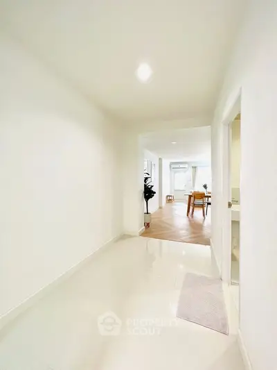 Bright hallway leading to a modern living area with elegant decor.