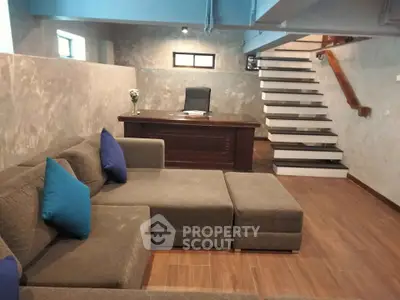 Stylish modern living room with sectional sofa and sleek staircase