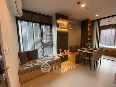 Modern apartment interior with cozy dining and seating area, featuring stylish decor and ample natural light.