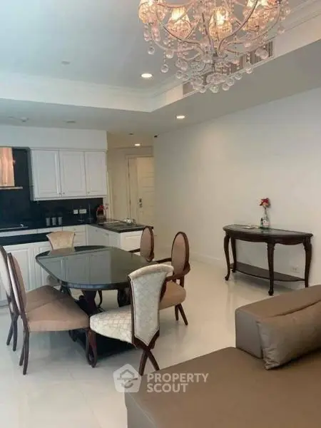 Elegant dining area with chandelier in modern open-layout apartment