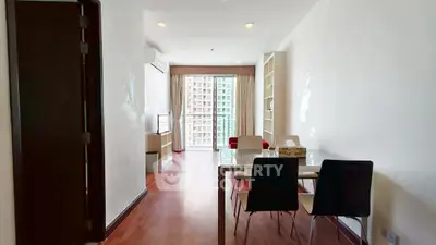 Spacious living room with modern furniture and large windows offering city views.