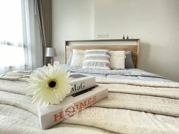 Cozy bedroom with stylish decor and natural light, perfect for relaxation.
