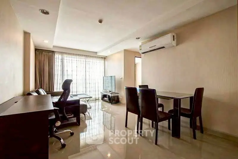 Spacious modern living room with dining area and sleek furniture in a well-lit apartment.