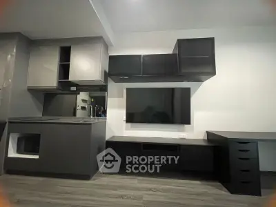 Modern kitchen with sleek cabinetry and integrated appliances in a stylish apartment.