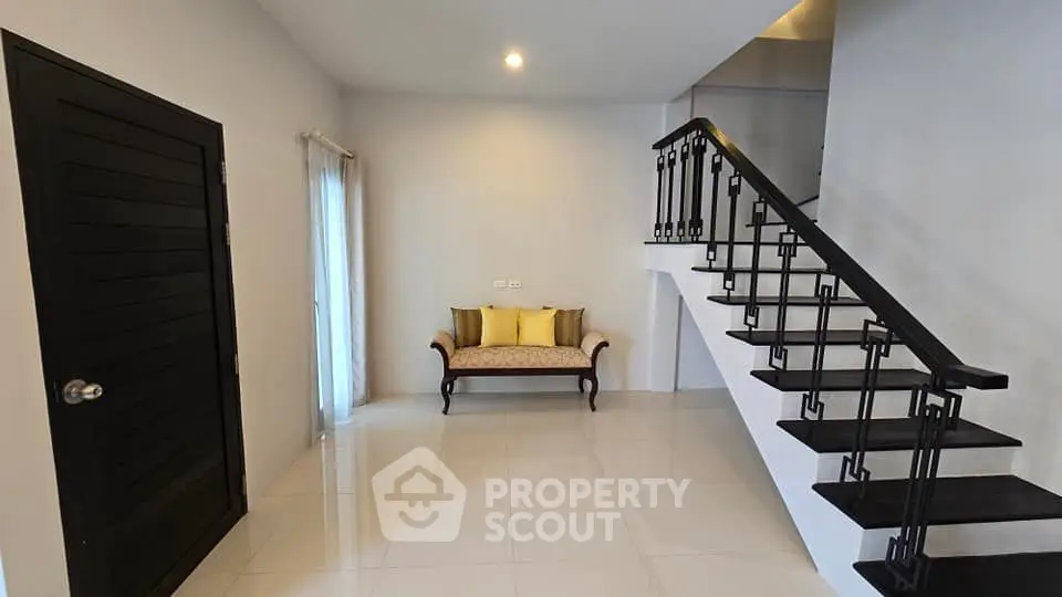 Modern minimalist interior with stylish staircase and cozy seating area