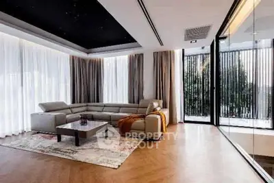 Luxurious modern living room with large windows and elegant decor