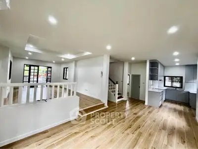 Spacious open-plan living area with modern kitchen and wooden flooring