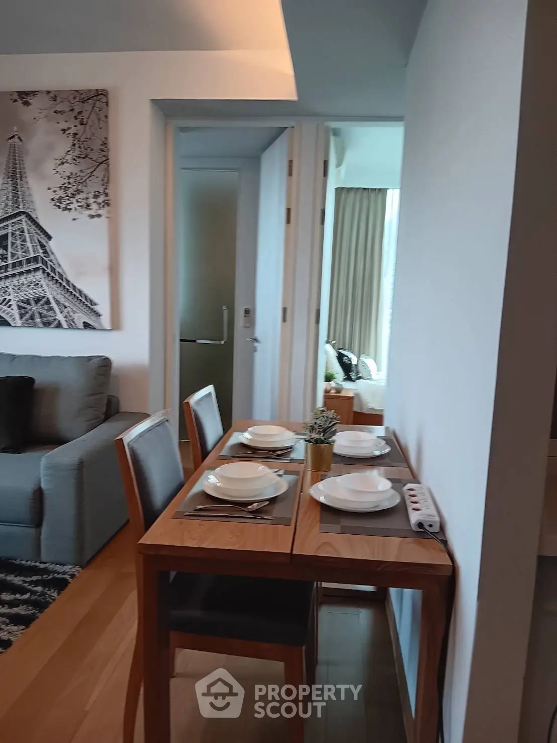 Modern dining area with wooden table and chairs in stylish apartment