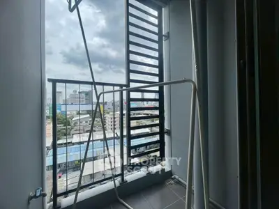 Urban balcony with city view and drying rack, perfect for modern living.