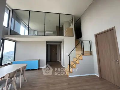 Modern duplex apartment with large windows and wooden staircase